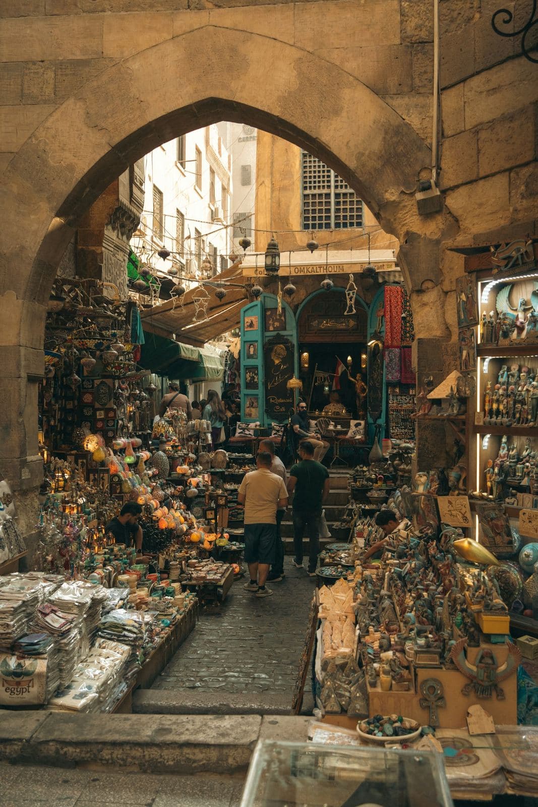 Market stalls under a stone archway in Khan el-Khalili, Cairo